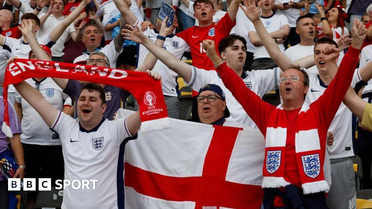 A single UK police officer in a high-visibility vest looks out at a vast crowd of England supporters singing in a stadium concourse, highlighting the 37-officer shortfall.