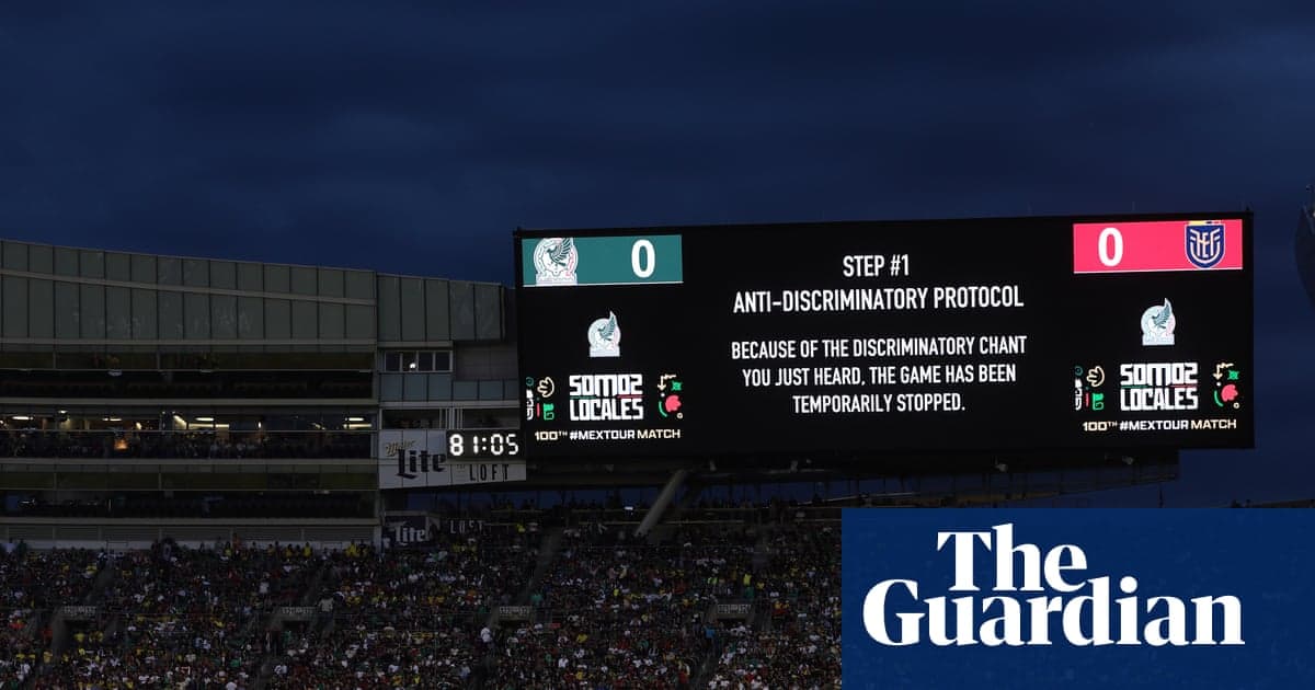 A stadium scoreboard displaying a FIFA message that the Mexico match has been temporarily stopped due to discriminatory chanting from the crowd.