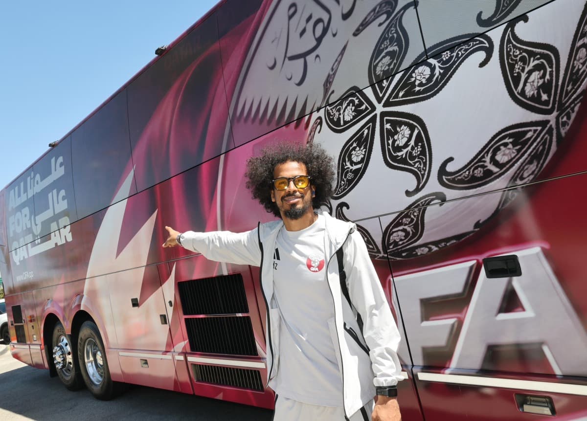Akram Afif of Qatar next to team bus in Santa Barbara, USA, ahead of World Cup 2026.