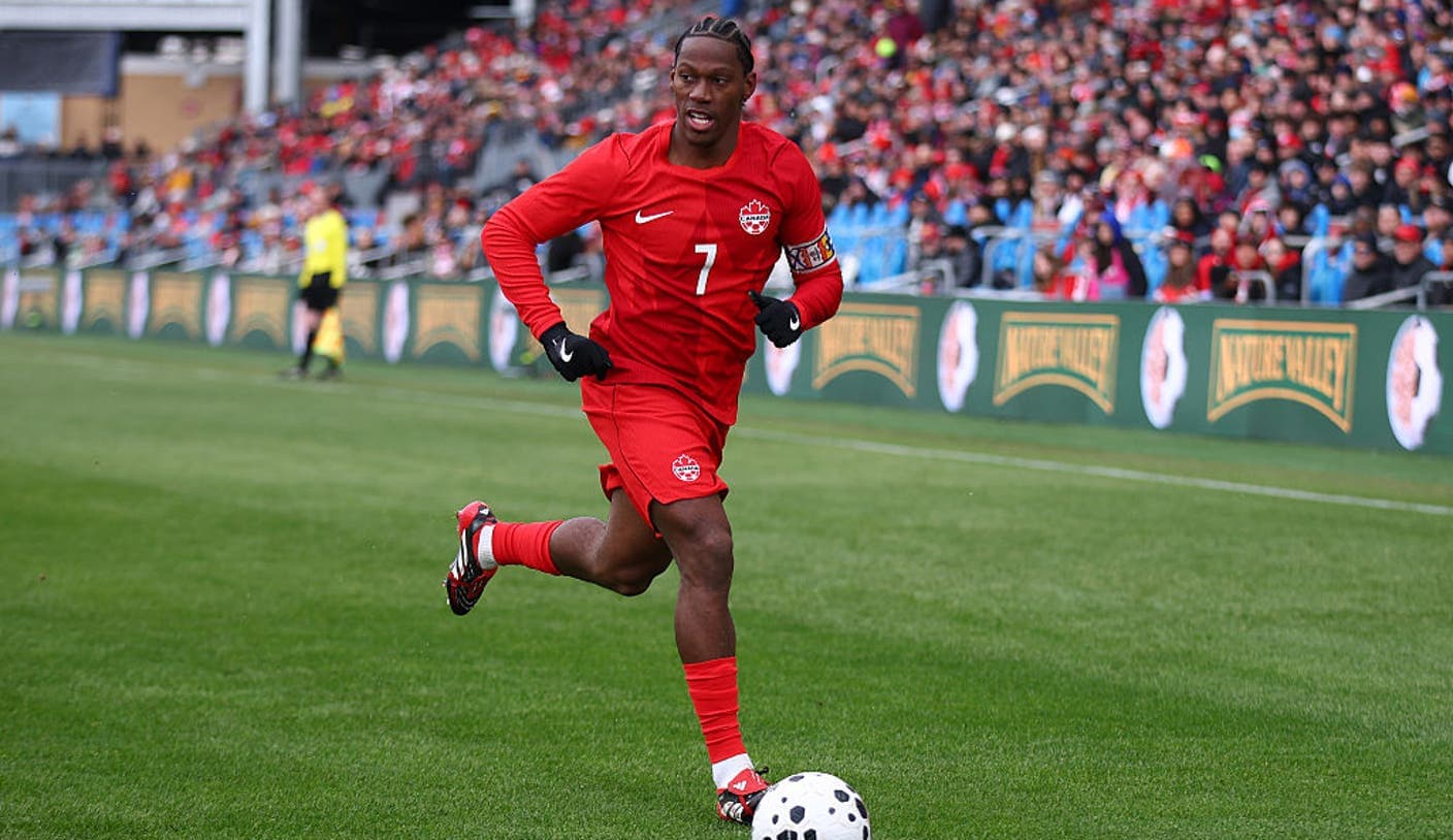 Alphonso Davies dribbles past an Uzbekistan defender during the Canada vs Uzbekistan international friendly at Commonwealth Stadium, Edmonton.