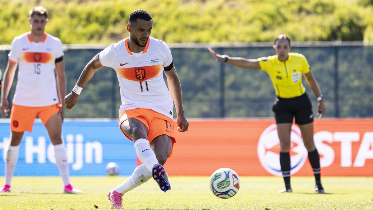 Bart Verbruggen lies on the ground clutching his leg after an awkward landing during the Netherlands' final World Cup warm-up match against Uzbekistan.