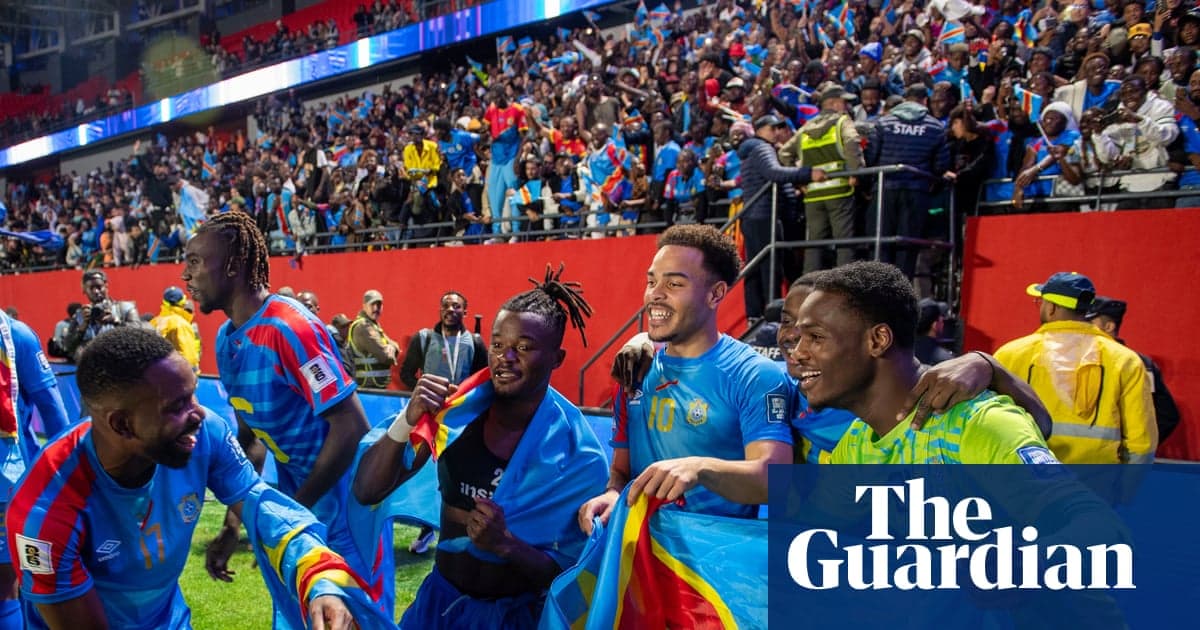 DR Congo national team players celebrating together on the pitch after a qualifying victory, wearing white and blue jerseys.