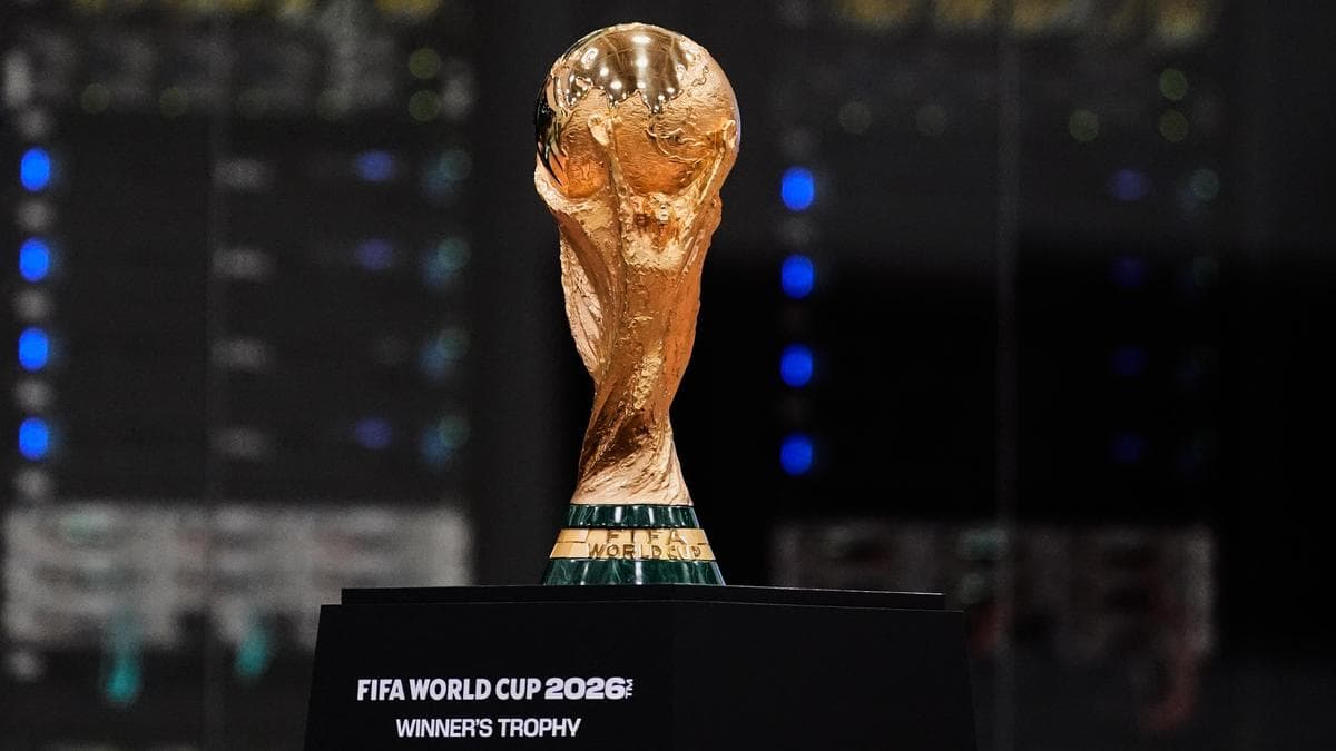 FIFA World Cup 2026 official logo with the flags of the United States, Canada, and Mexico in the background.