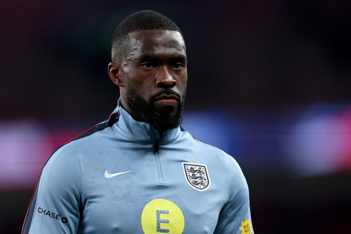 Fikayo Tomori in an AC Milan warm-up top looks on solemnly during England's friendly against Uruguay at Wembley, weeks before the 2026 World Cup squad announcement.