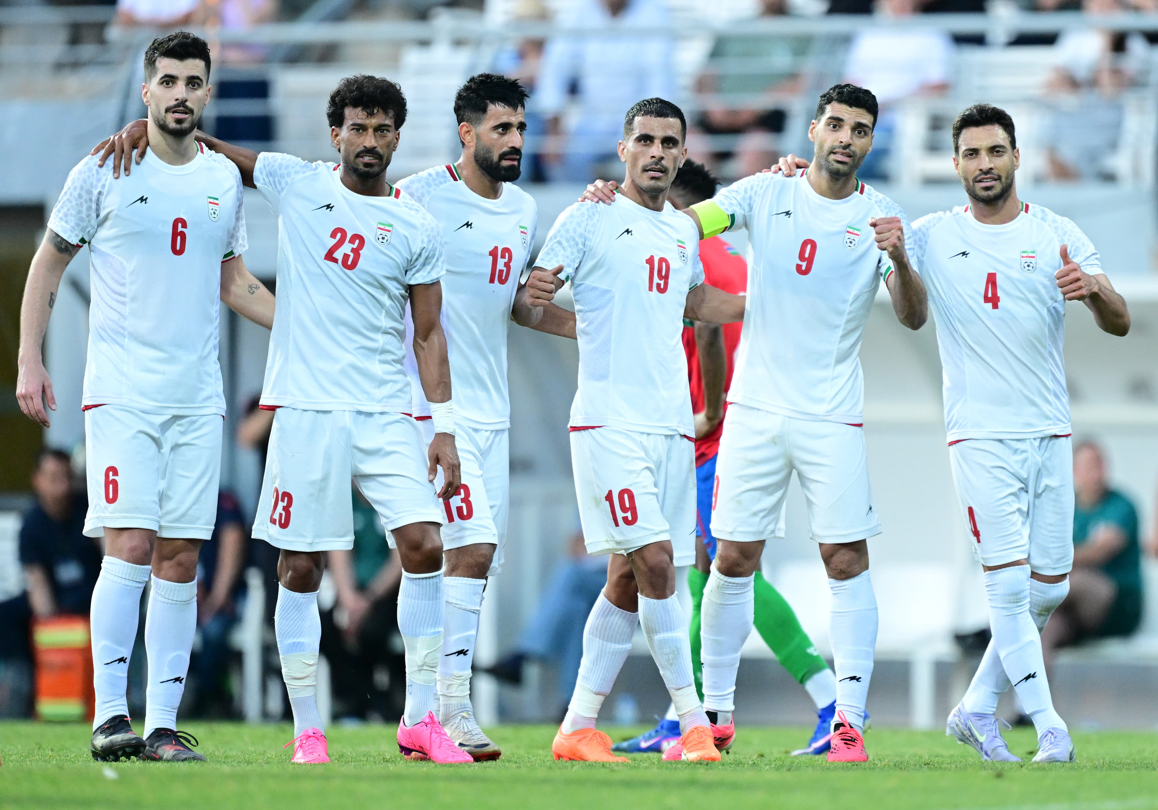 Iranian football players in white kits walking on the pitch during a friendly match in Turkey on May 29, 2026, ahead of the World Cup.