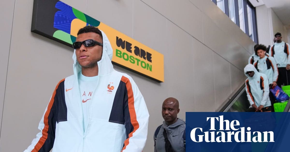 Kylian Mbappé arriving at Boston's Logan airport with France teammates on an escalator behind him