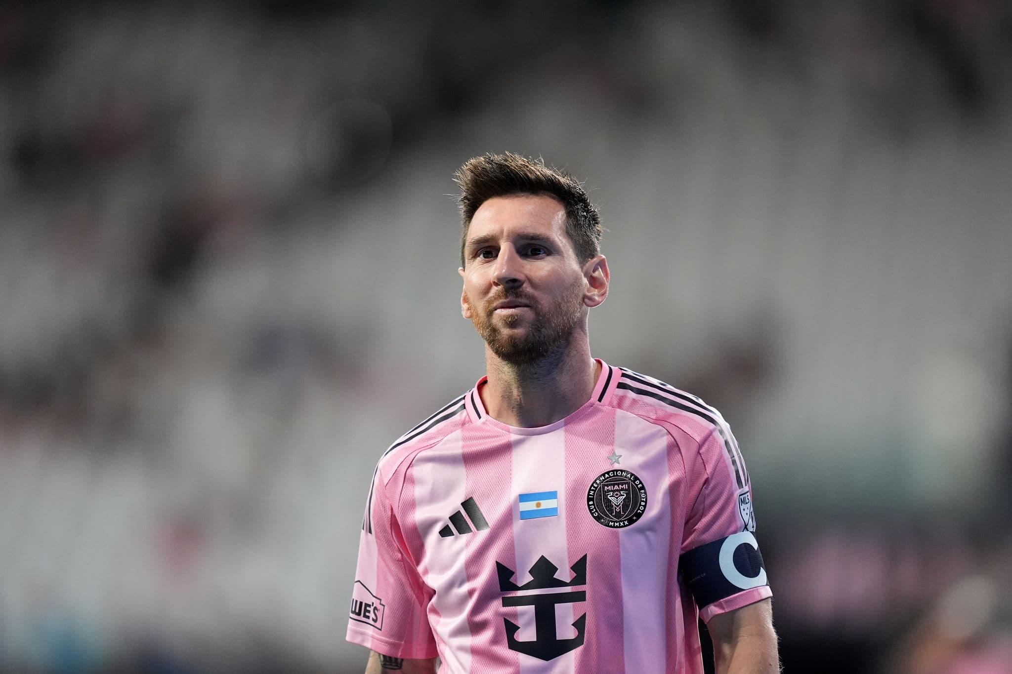 Lionel Messi clutching his left hamstring while playing for Inter Miami, with a distressed expression, ahead of the 2026 World Cup.