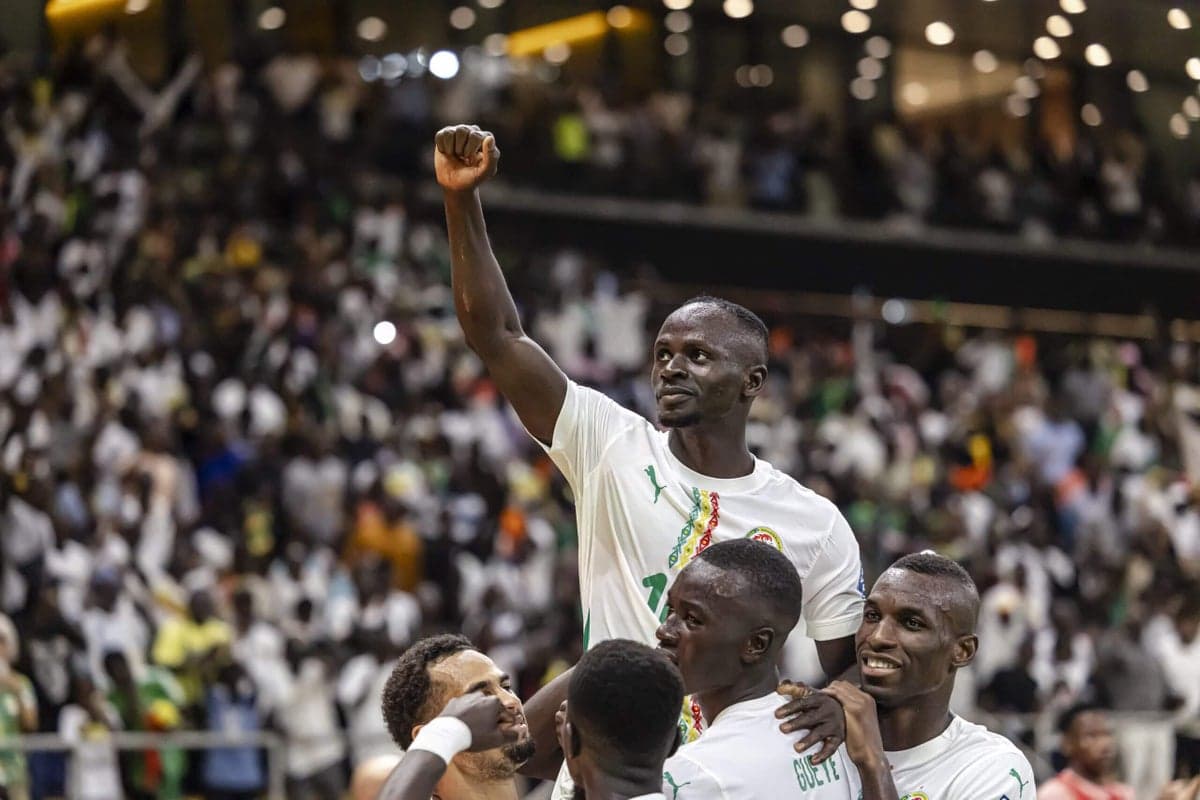 Sadio Mané celebrating a goal with his Senegal teammates during World Cup qualifying, symbolizing the greater opportunities for African nations in the expanded 48-team tournament.
