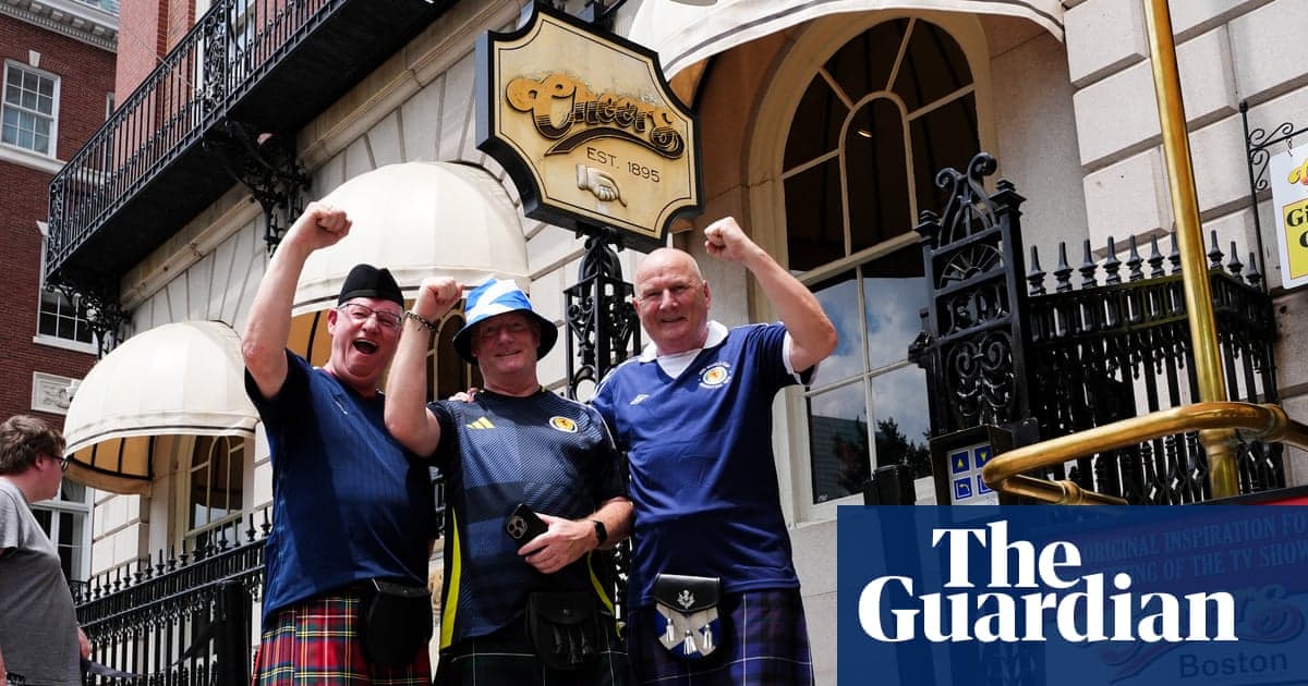 Scotland fans celebrating outside the Cheers Restaurant & Pub in Boston, waving flags and wearing kilts during the 2026 World Cup.