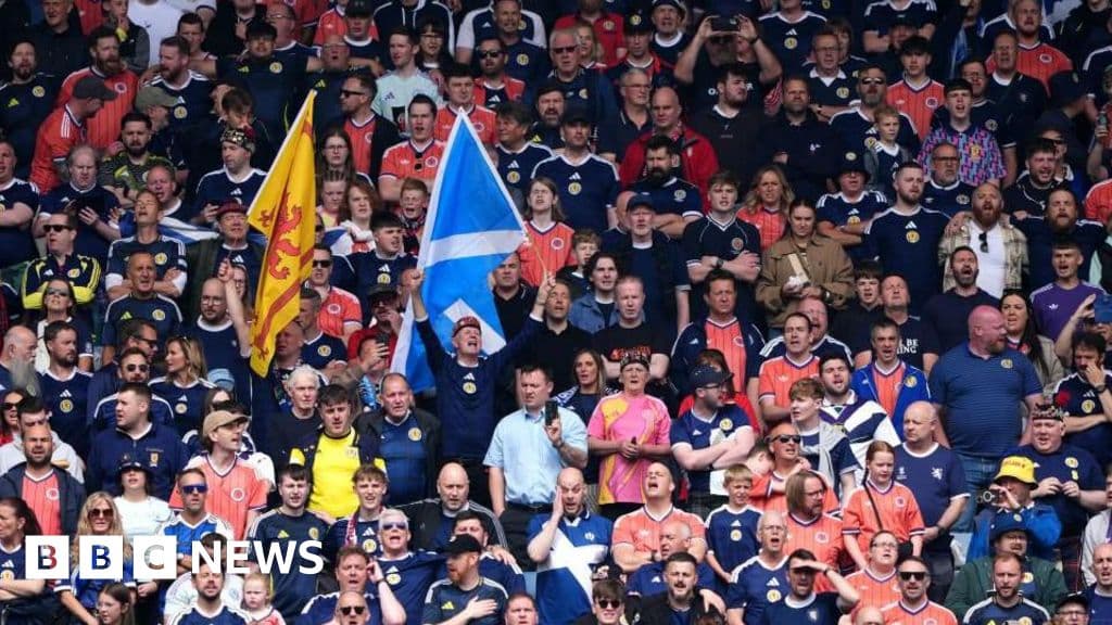 Scotland supporters in a stadium with empty seats visible, illustrating the unsold ticket problem for the 2026 World Cup.