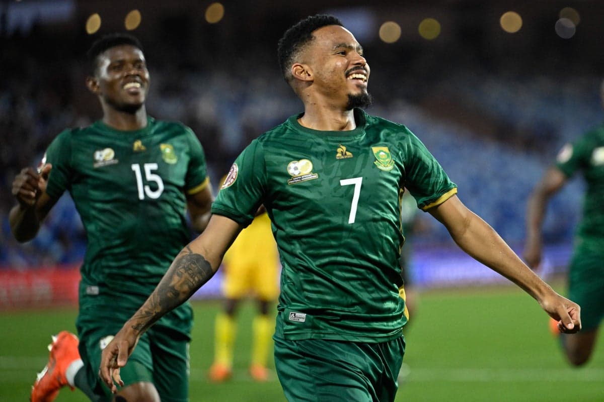 South Africa's Oswin Appollis celebrating a goal during a World Cup qualifier, a scene from pre-tournament preparations now overshadowed by a logistical crisis.