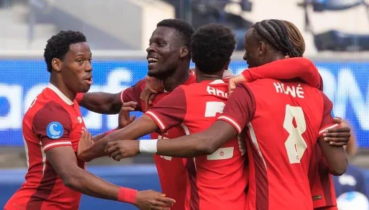 Split image of Canada's Tani Oluwaseyi and Jonathan David, key attackers for the 2026 World Cup co-hosts, poised side-by-side.