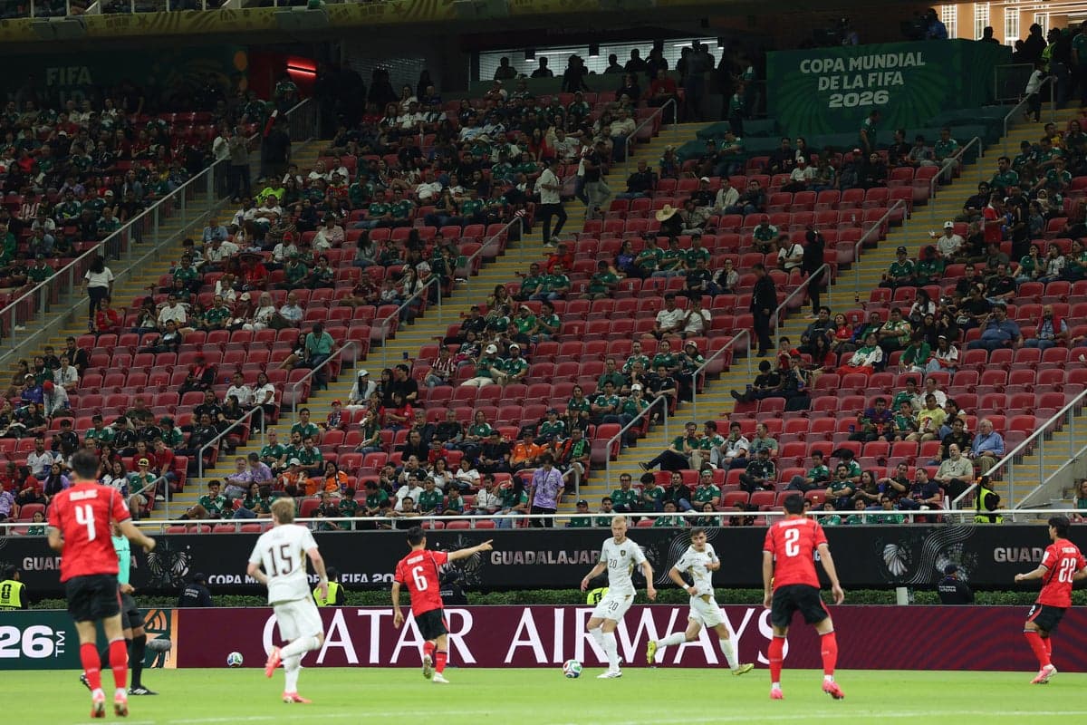 Thousands of empty blue seats visible in the upper tier of a stadium during a 2026 World Cup match between South Korea and the Czech Republic in Guadalajara.
